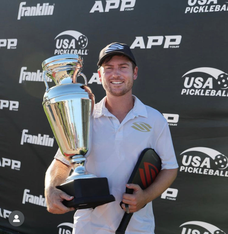 Pro pickleball player Kyle Lewis holding a trophy from the Sacramento APP Open
